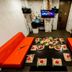 Raha Grand Hotel Patong in Patong: private karaoke room with orange sofas and low table set for dining
