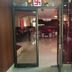 Entrance to Hotel Maiden Residency in Ghāziābād with a glass doorway and lounge seating inside