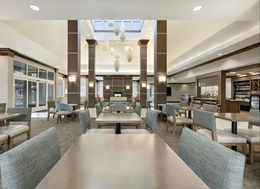 Hilton Garden Inn Dulles North in Ashburn lobby dining area with tables and skylight