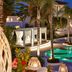 Caramel, A Grecotel Resort to Live in Adelianos Kampos, poolside cabanas and palm trees at night