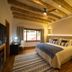 Visus Hotel Boutique & Spa room with exposed wood beams, king bed, and window view in Fonda Central