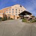 Comfort Suites Airport Tukwila Seattle exterior with covered entrance and landscaped driveway