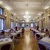 Grand Hotel des Bains in Lavey-Morcles: elegant formal dining room with chandeliers and set tables