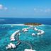Diamonds Thudufushi Beach & Water Villas, Thudufushi: overwater villas on a turquoise lagoon with island view