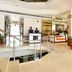 Hotel Shipra International lobby in New Delhi with front desk, staff, and polished marble flooring