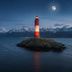 Hostal de la Laguna in Ushuaia with a lighthouse on a rocky islet beneath a moonlit mountain backdrop