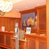 Stadthotel Augsburg reception area with wood-paneled front desk and warm pendant lights in Augsburg