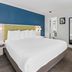 SureStay by Best Western Santa Monica guest room with king bed and blue accent wall