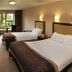 Westport Woods Hotel & Spa in Westport guest room with two beds, desk and garden-view window