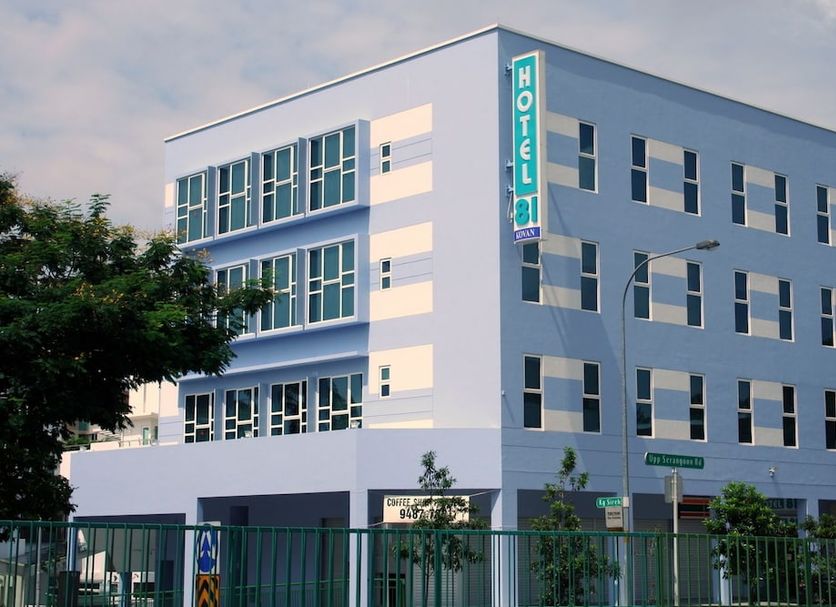 Hotel 81 Kovan in Singapore, modern 4-story hotel exterior with corner sign at dusk