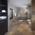 Villa Hening Jimbaran bathroom with double sinks, toilet, and stone soaking tub in South Kuta