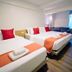 Wild Orchid Villa Bangkok in Bangkok guest room with three beds and orange accents