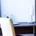 Hotel Vinothek Schwarzer Adler in Ottensheim: desk, chair and wall-mounted lamp in a guest room