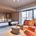 Mitsui Garden Hotel Kashiwa-No-Ha guest room with twin beds, sofa, and city view in Kashiwa