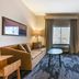 Fairfield by Marriott Inn & Suites Sandusky room with sofa, desk, TV, and window view