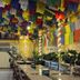 Boudha Stupa View Guest House in Kathmandu patio with colorful prayer flags, tables, benches, and plants