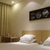 Pod Inn Nanjing Xuanwu Lake Xuanwumen Station room with twin beds, curtains, and wall art in Nanjing