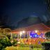 Hotel Cocomar Beachfront Hotel in Parrita, lit beachfront bungalow with tropical garden and palm trees at night
