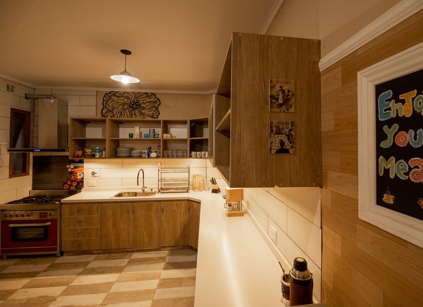 Che Juan Hostel Ba in Buenos Aires kitchen with wooden cabinets, checkered floor and lit counter