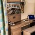 Pension Kreuzjoch in Zell am Ziller guest room desk with mirror, bench, and balcony curtains