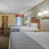 SureStay by Best Western Kansas City Country Inn North guest room with two beds and TV