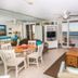 Pelican Beach Resort & Conference Center in Destin living area with ocean-view balcony and striped sofa