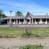 Red Carpet Inn North East exterior with low motel-style building, parking lot, and grassy frontage