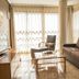 Apartamentos Plaza Picasso Valencia apartment living room with sofa, armchair, TV and bright balcony windows