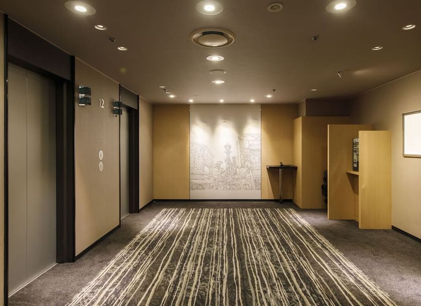 Shin Osaka Esaka Tokyu Rei Hotel Suita elevator lobby with patterned carpet and wall art