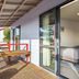 Kaikoura TOP 10 Holiday Park balcony with wooden table and view into bedroom, Kaikoura