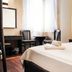 Hotel Guleryuz in Antalya guest room with double bed, desk, chairs and bright window light