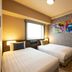Just Sleep Osaka Shinsaibashi in Osaka, twin guest room with two beds, desk, and colorful wall art