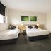Nightcap at St Albans Hotel room in Saint Albans with two single beds and wall art