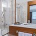 Nearport Hotel Sabiha Gokcen Airport bathroom with glass shower and wood vanity in Istanbul