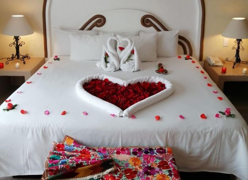 Hotel Real de Minas Tradicional in Santiago de Querétaro with a heart-shaped rose petal bed arrangement and swan towels