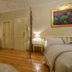 Villa Olivia Split guest room with bed, kitchenette, polished wood floor, and painting