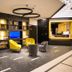 Best Western Hotel Journel Saint-Laurent-du-Var lounge with yellow chairs and built-in shelving in Saint-Laurent-du-Var