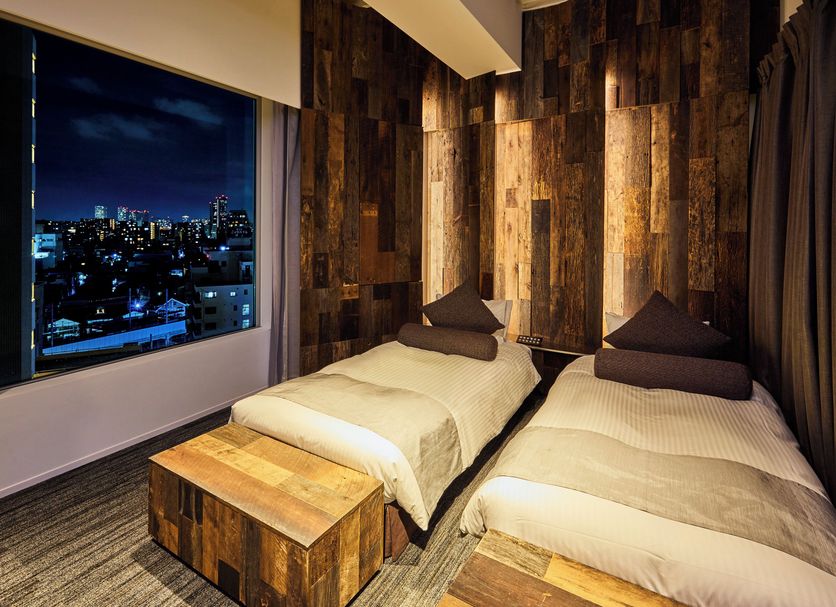 ONE@Tokyo by insomnia in Tokyo guest room with twin beds and city skyline view
