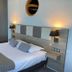 Hôtel Des Princes room in Évian-les-Bains with double bed, bedside lamps and wall mirror