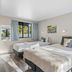 Tasman Holiday Parks - Christchurch room with two beds, window view, and bedside tables