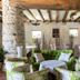 Domaine de Bassilour in Bidart, cozy lounge with green chairs, stone pillar and rustic wood-beam ceiling