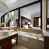 JW Marriott Hotel Bengaluru bathroom with soaking tub, double vanity and large mirror