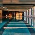 Crowne Plaza Sofia by IHG indoor pool with floor-to-ceiling windows and modern lounge seating