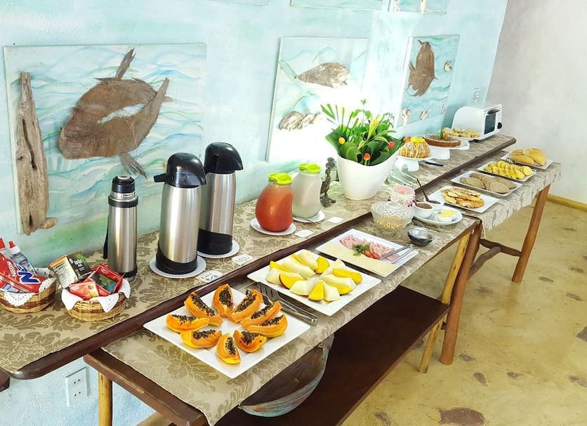 Art Hotel Aos Sinos Dos Anjos in Arraial d'Ajuda breakfast buffet with coffee urns, juice and pastries