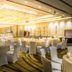Winford Resort & Casino Manila ballroom with round banquet tables and white chair covers in Manila