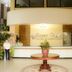 Sunny Point Hotel lobby with front desk, central table, and plant in Davao City
