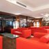 Exe Convention Plaza Madrid lounge with red sofas, glass coffee table and city views in Madrid