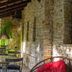 Pousada Villa Das Pedras in Pirenópolis stone terrace with table, chairs and hanging greenery
