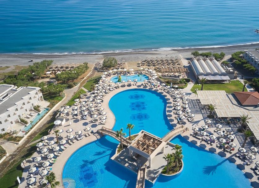 Atlantica Ocean Beach Resort in Maleme with large oceanfront pool, sun loungers, and sea views