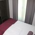 Fair Hotel Europaallee in Frankfurt am Main guest room with bed, desk, chair and window curtains